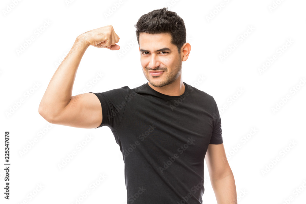 Attractive Young Man Dressed In Black Tshirt Showing His Biceps Attractive Young Man Dressed In Black Tshirt Showing His Biceps