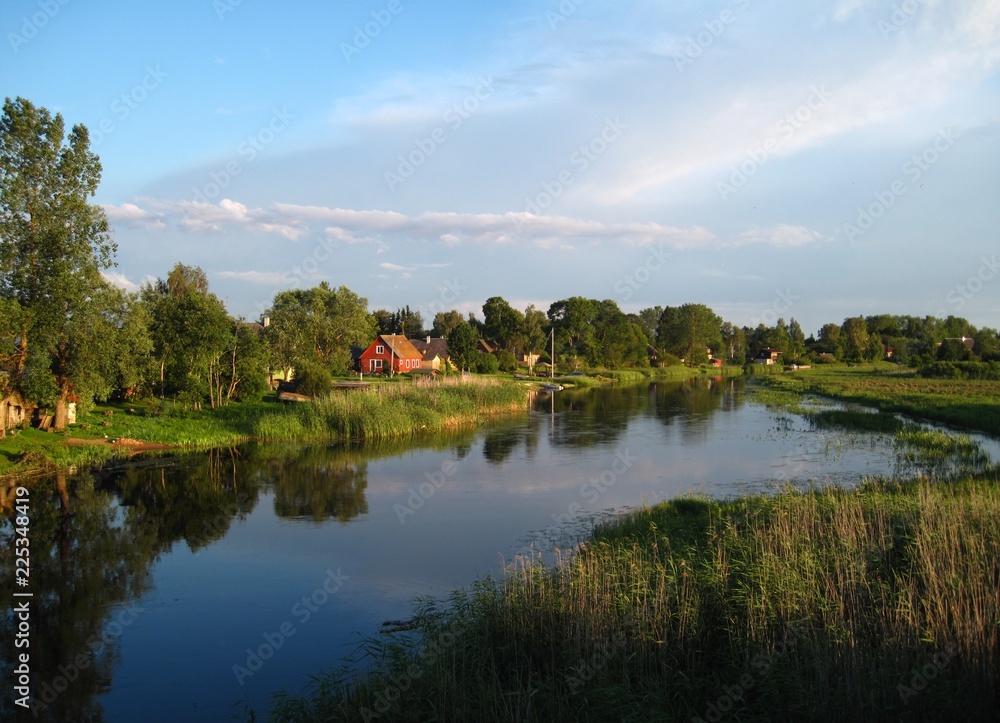 South Estonia riverside countryside view with a red wooden house