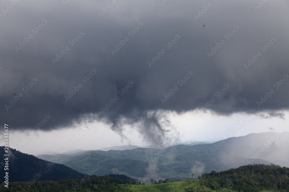 The could is flying from the forest to the sky to become a rain