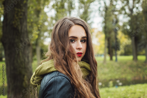 Cute woman in green cotton scarf outdoor, portrait