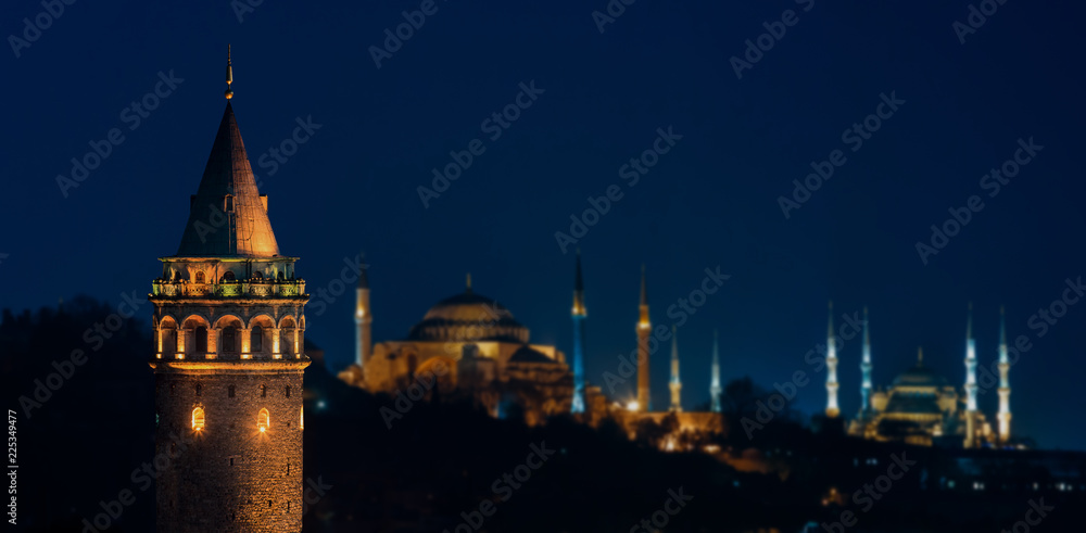 Galata Tower at night with Hagia Sophia and The Blue Mosque in Istanbul
