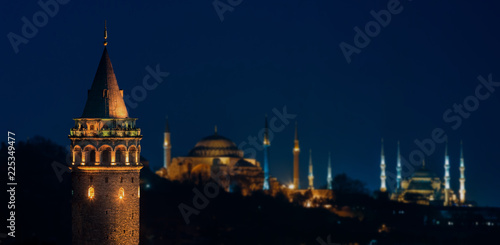 Galata Tower at night with Hagia Sophia and The Blue Mosque in Istanbul