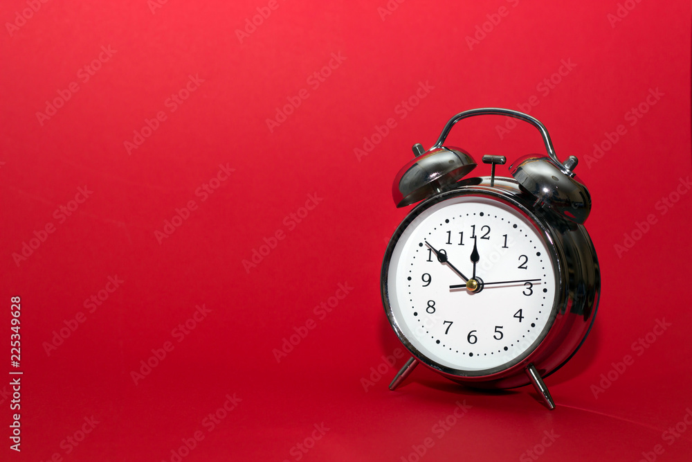 alarm clock on red background. close up shot. top view, time concept. alarm clock on red background. close up shot. top view, time concept.