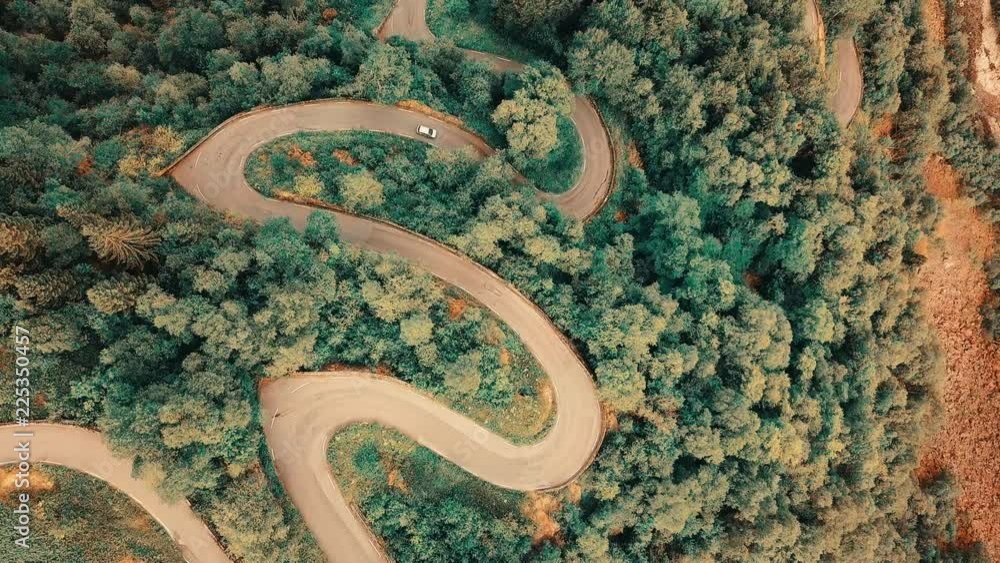Aerial View landscape serpentine road winding on the mountains background in summer sunny day, Drone 4K Video

