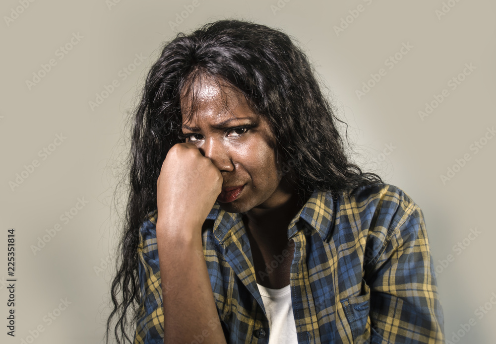 young sad and depressed black African American woman crying anxious and overwhelmed feeling sick and stressed isolated on studio background suffering depression young sad and depressed black African American woman crying anxious and overwhelmed feeling sick and stressed isolated on studio background suffering depression