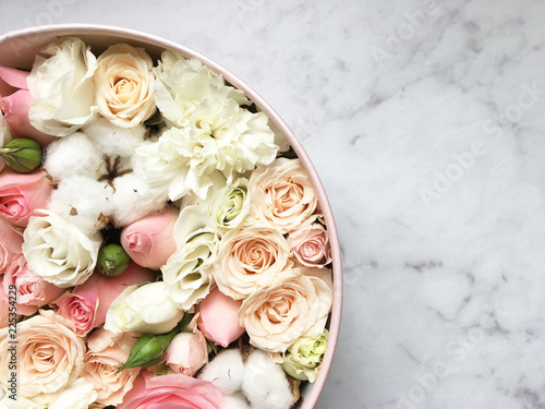 Flowers in a box roses and colorful macaroons macaroni marshmallow cotton