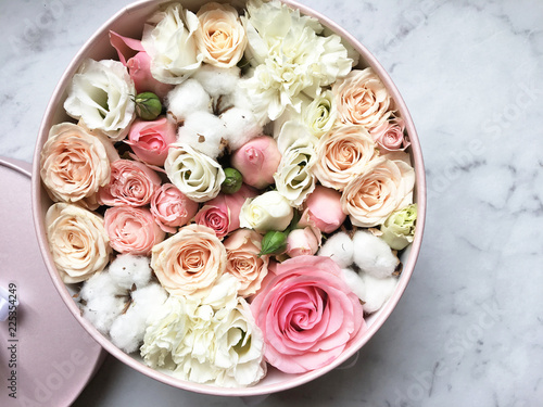 Flowers in a box roses and colorful macaroons macaroni marshmallow cotton