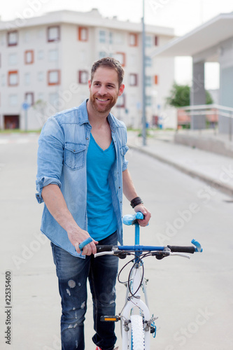 Cool guy with a vintage bicycle in the city