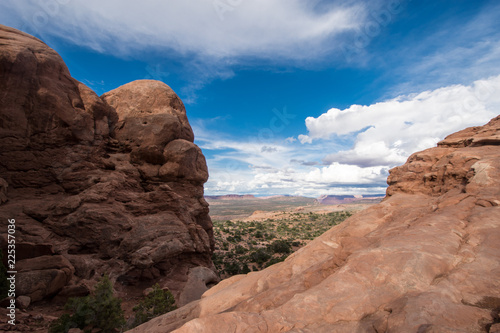 Giant red rock formations inside of Utahs Arches National Park. Blue sky and clouds