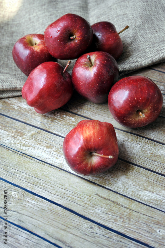 Fresh red apples on the wooden background with sack.selective focus. blurred background Fresh red apples on the wooden background with sack.selective focus. blurred background