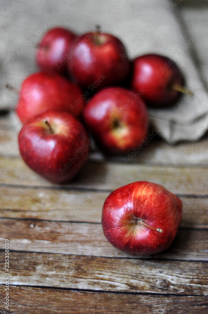 Fresh red apples on the wooden background with sack.selective focus. blurred background Fresh red apples on the wooden background with sack.selective focus. blurred background