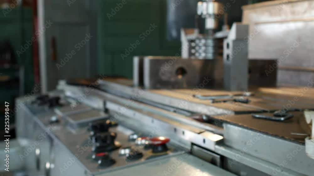 A private workshop for working with metal parts, in the background a drilling machine drills a hole in the pulley, on the table lie measuring instruments, workshop A private workshop for working with metal parts, in the background a drilling machine drills a hole in the pulley, on the table lie measuring instruments, workshop