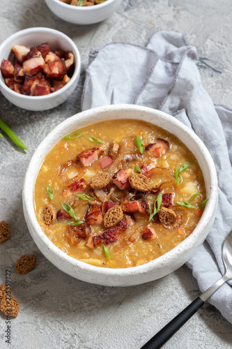 Lentil pea soup garnish with bacon and croutons