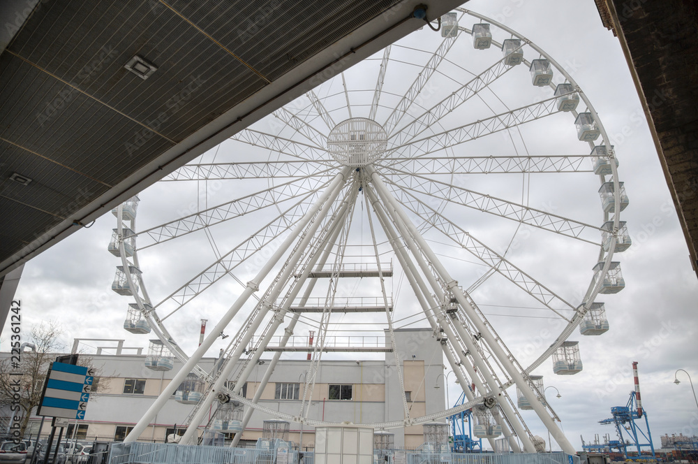 image of a large white Ferris wheel used as a tourist attraction
