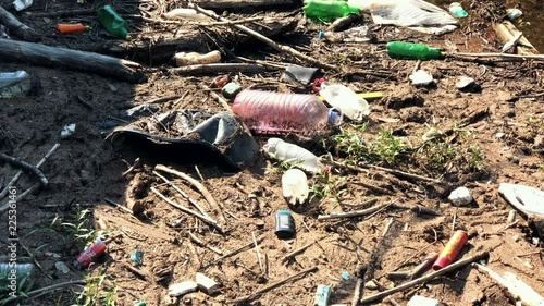 Plastic garbage thrown in the lake by humans.