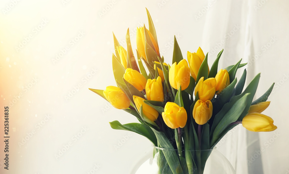A bouquet of red tulips in a vase on the windowsill. A gift for A bouquet of red tulips in a vase on the windowsill. A gift for