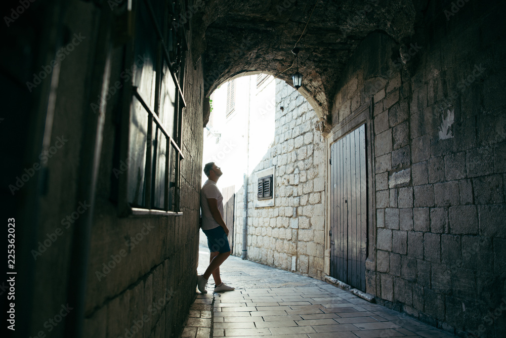 man standing in tunnel in kotor town