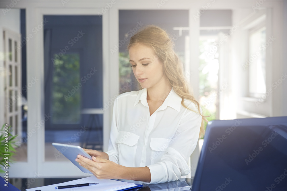 Businesswoman with digital tablet in the office Businesswoman with digital tablet in the office