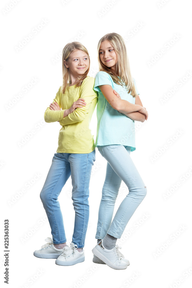 Cute girls in casual clothing posing on white background