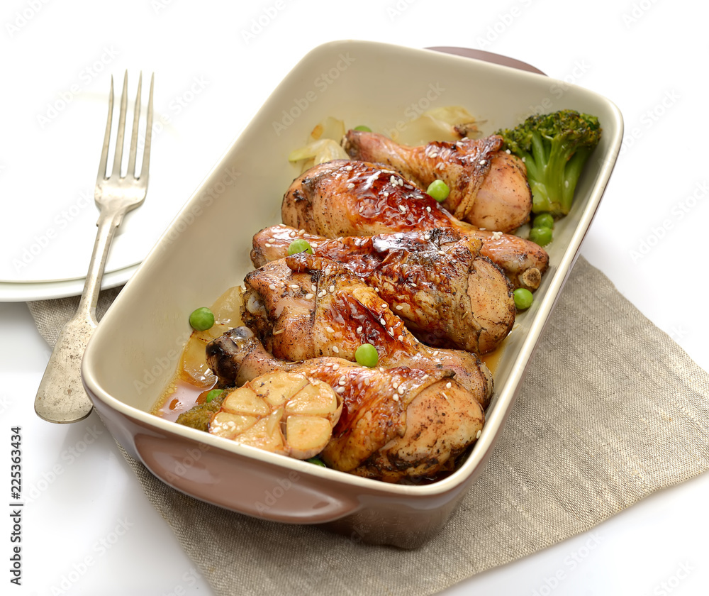 grilled chicken legs with sesame in a plate on a white background grilled chicken legs with sesame in a plate on a white background