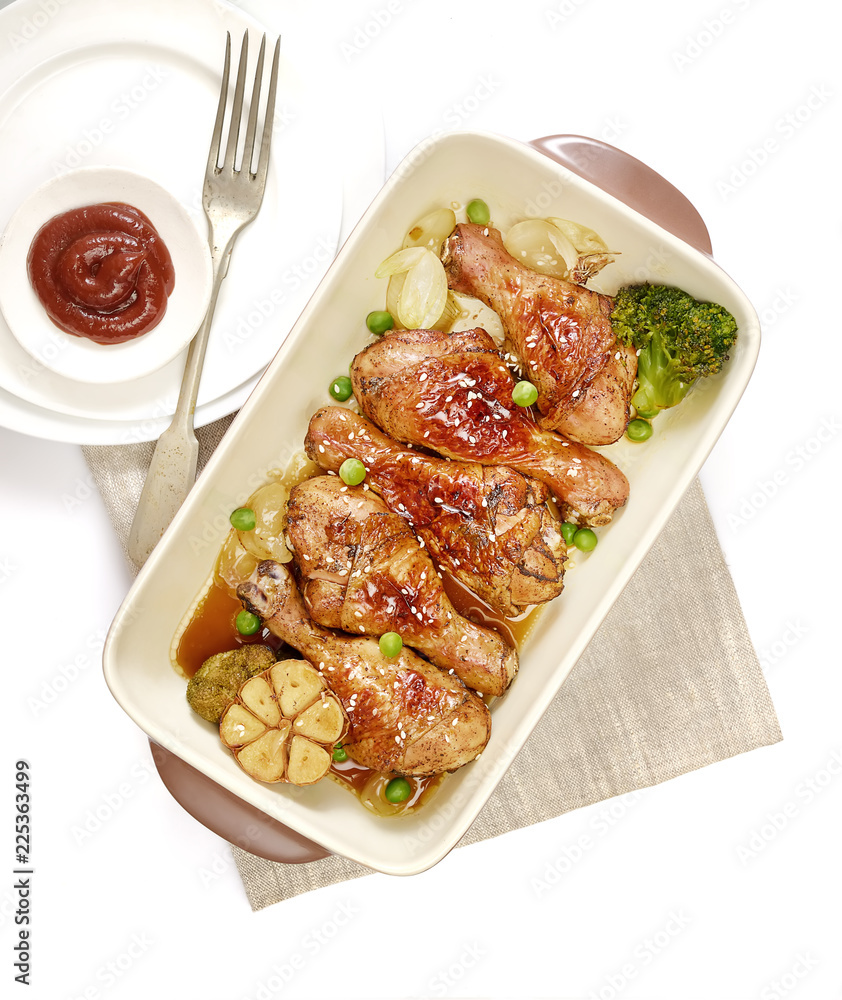 grilled chicken legs with sesame in a plate on a white background grilled chicken legs with sesame in a plate on a white background