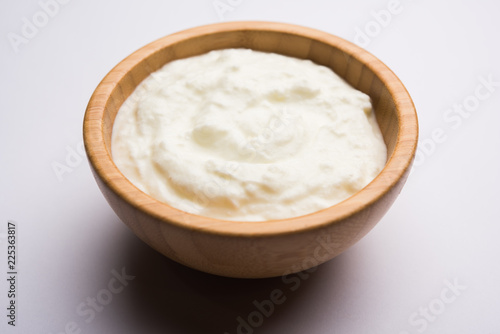 Plain curd or yogurt or Dahi in Hindi, served in a bowl over moody background. Selective focus photo