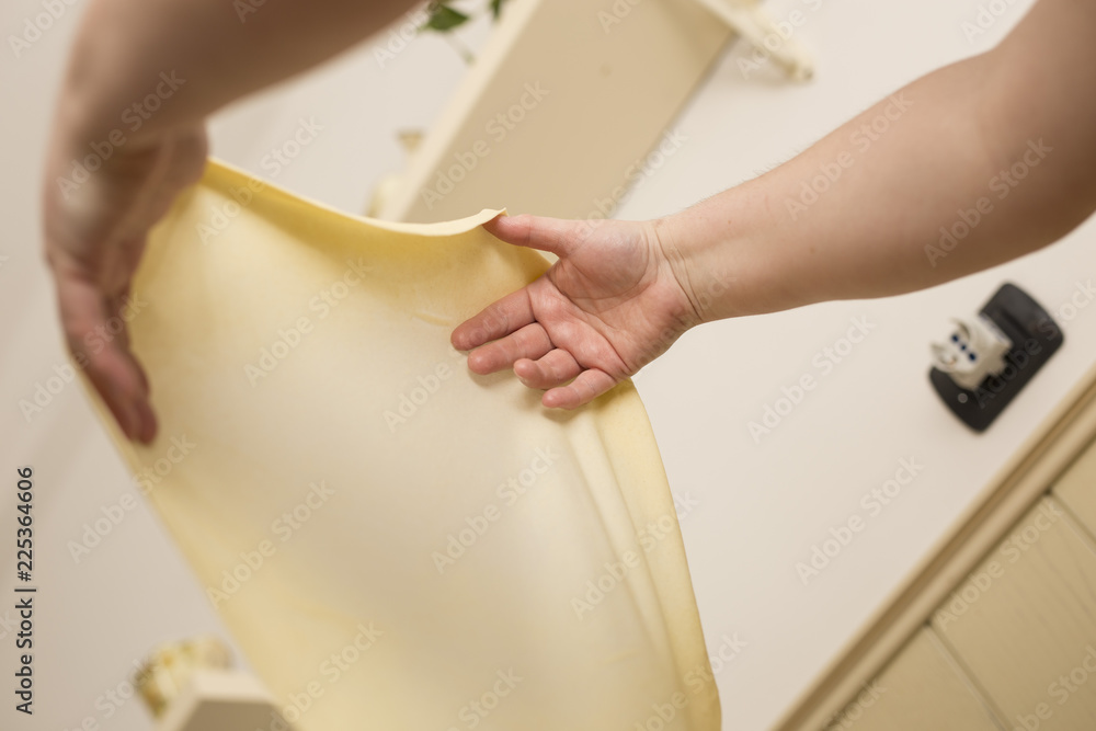 horizontal image of woman's hands stretching and working pizza dough