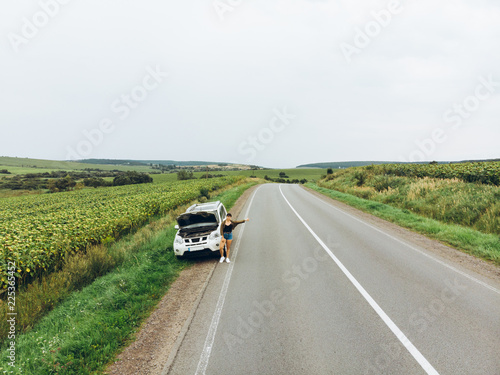 woman stuck with broken car in the middle of nowhere.