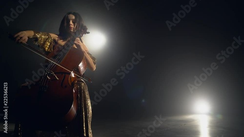 The cellist performs on stage. photo