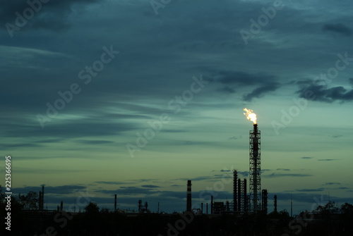 Fototapeta night silhouette industrial landscape - flares for flaring associated gas in an oil field