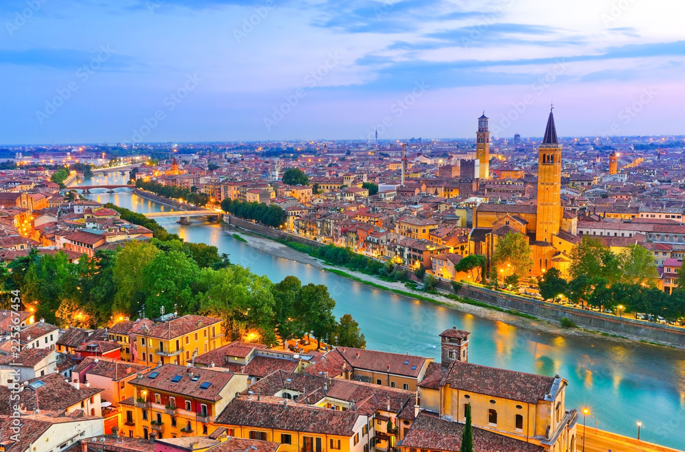 View of the historic city center along Adige river at dusk in Verona, Italy.