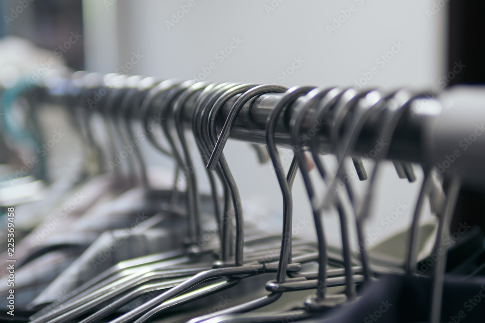 Fototapeta premium Clothes hangers on clothes rack