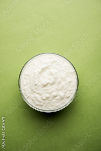 Plain curd or yogurt or Dahi in Hindi, served in a bowl over moody background. Selective focus