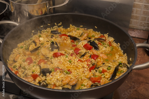 horizontal image of a pan on fire during the preparation of the paella