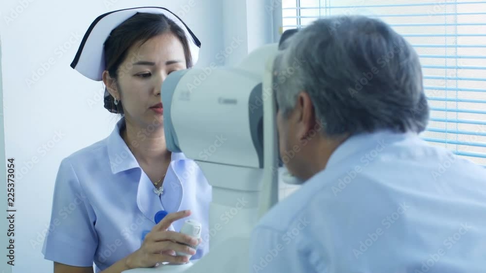Female nurse examining eyes of elderly patient in office at the hospital. Female nurse examining eyes of elderly patient in office at the hospital.