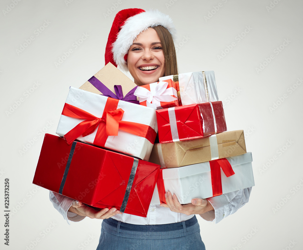 Happy woman wearing santa hat holding pile of gifts. Happy woman wearing santa hat holding pile of gifts.