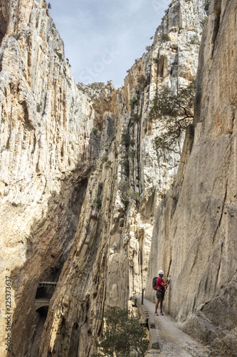 One person in the amazing famous "Caminito del Rey" a path at 100m above the ground on a steep gorge called "Desfiladero de los Gaitanes", best trekkings in Andalusia and Spain, an awesome adventure © abriendomundo