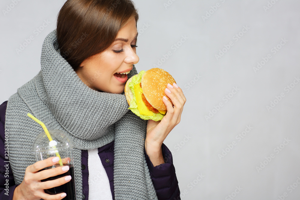 Woman eating burger with closed eyes. Isolated