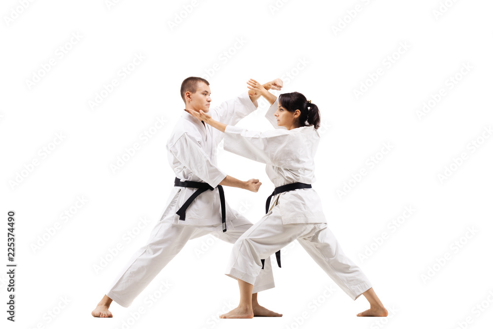 karate girl and boy fighting against white background