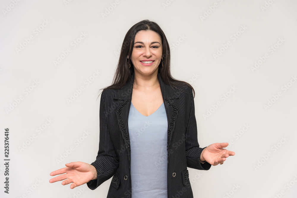 Portrait of a beautiful brunette woman on a white background with different emotions. She stands directly in front of the camera Portrait of a beautiful brunette woman on a white background with different emotions. She stands directly in front of the camera