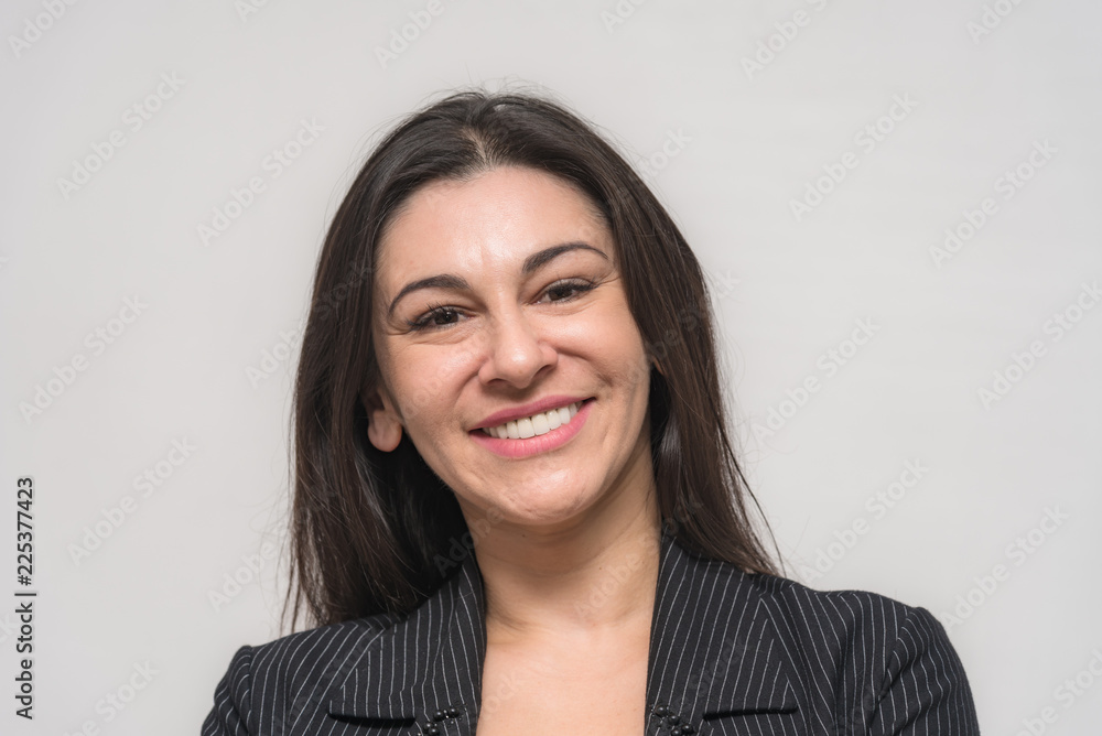 Portrait of a beautiful brunette woman on a white background with different emotions. She stands directly in front of the camera Portrait of a beautiful brunette woman on a white background with different emotions. She stands directly in front of the camera