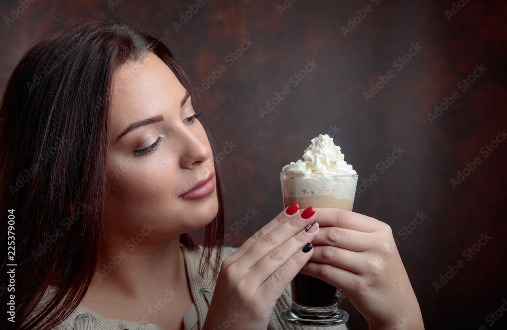Young  beautiful woman with dark hair picked up holding a  mug  coffee with cream.
