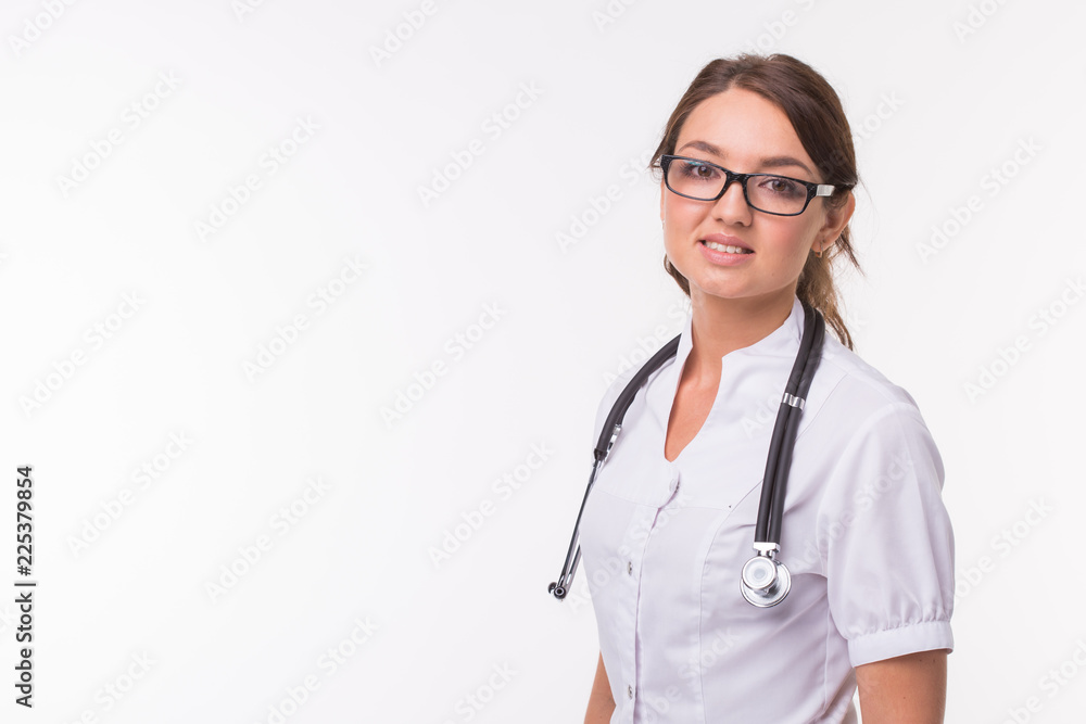 Medical concept of young beautiful female doctor in white coat with phonendoscope on white background with copy space. Medical concept of young beautiful female doctor in white coat with phonendoscope on white background with copy space.