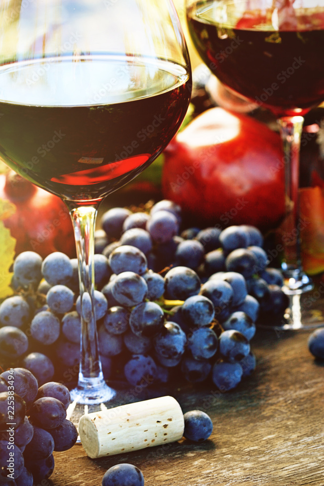 Closeup of glasses of red wine and grapes