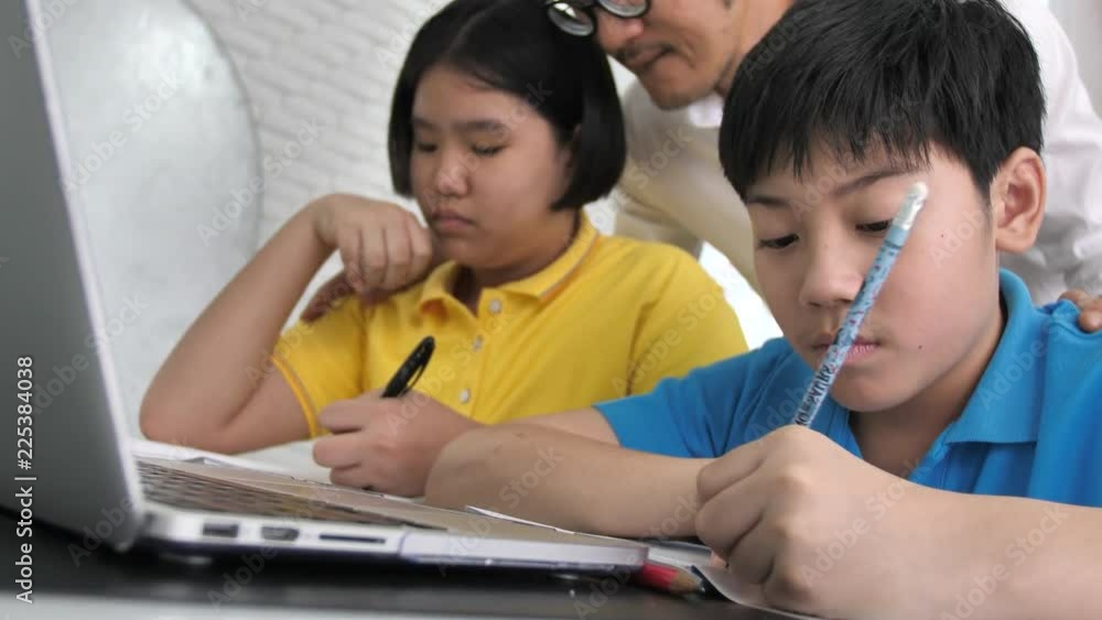 Tutor room children in class learning on laptop computer with teacher. 4K Slow motion Asian child learning with teacher at home. Tutor room children in class learning on laptop computer with teacher. 4K Slow motion Asian child learning with teacher at home.