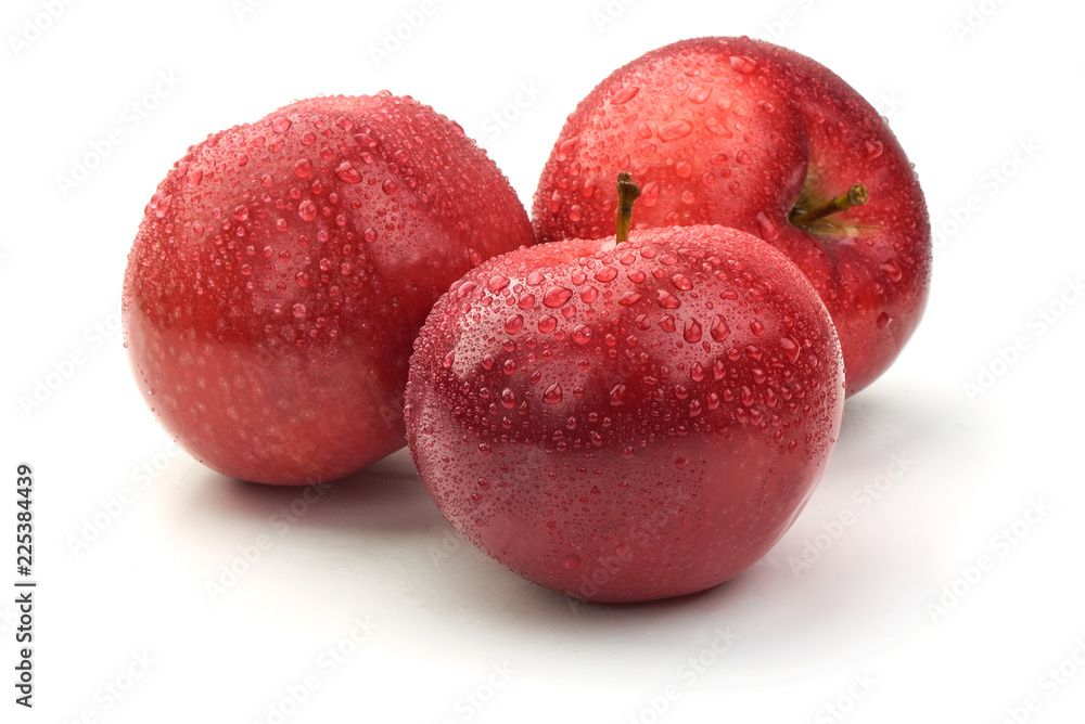 Obraz premium Red ripe apples with drops, isolated on white background. Fresh raw organic fruits.