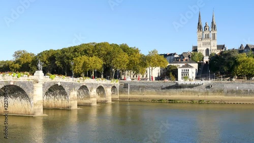 The Verdun bridge in Angers (France) is a bridge with masonry vaults. It is the oldest passage from one side of the Maine river to the other. In the background, there is the Cathedral of Angers. photo