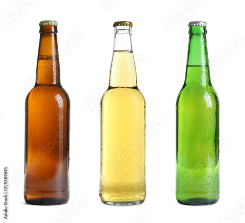 Set with different cold beer bottles on white background