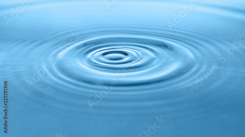 Blue water with concentric waves as background, closeup