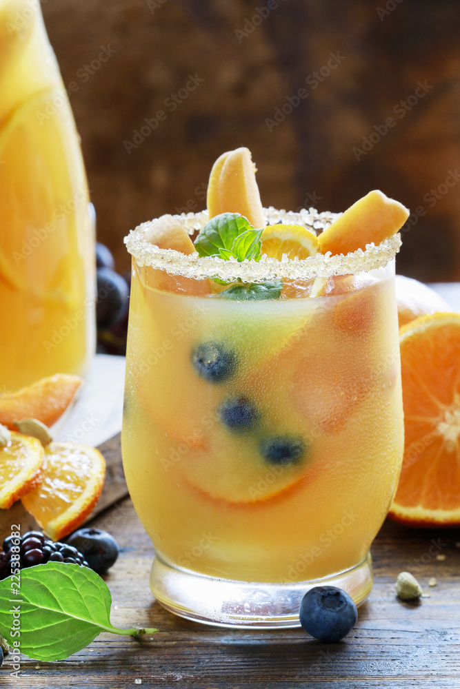 Summer drink with peaches, oranges and blueberries. Summer drink with peaches, oranges and blueberries.